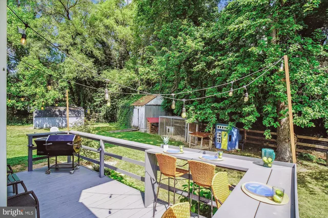 a view of a chairs and table on the wooden deck