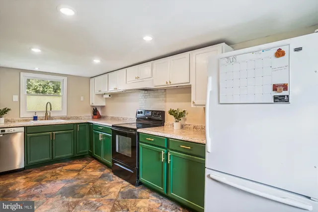 a kitchen with cabinets and white stainless steel appliances