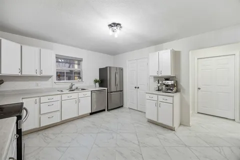 a kitchen with cabinets and white appliances