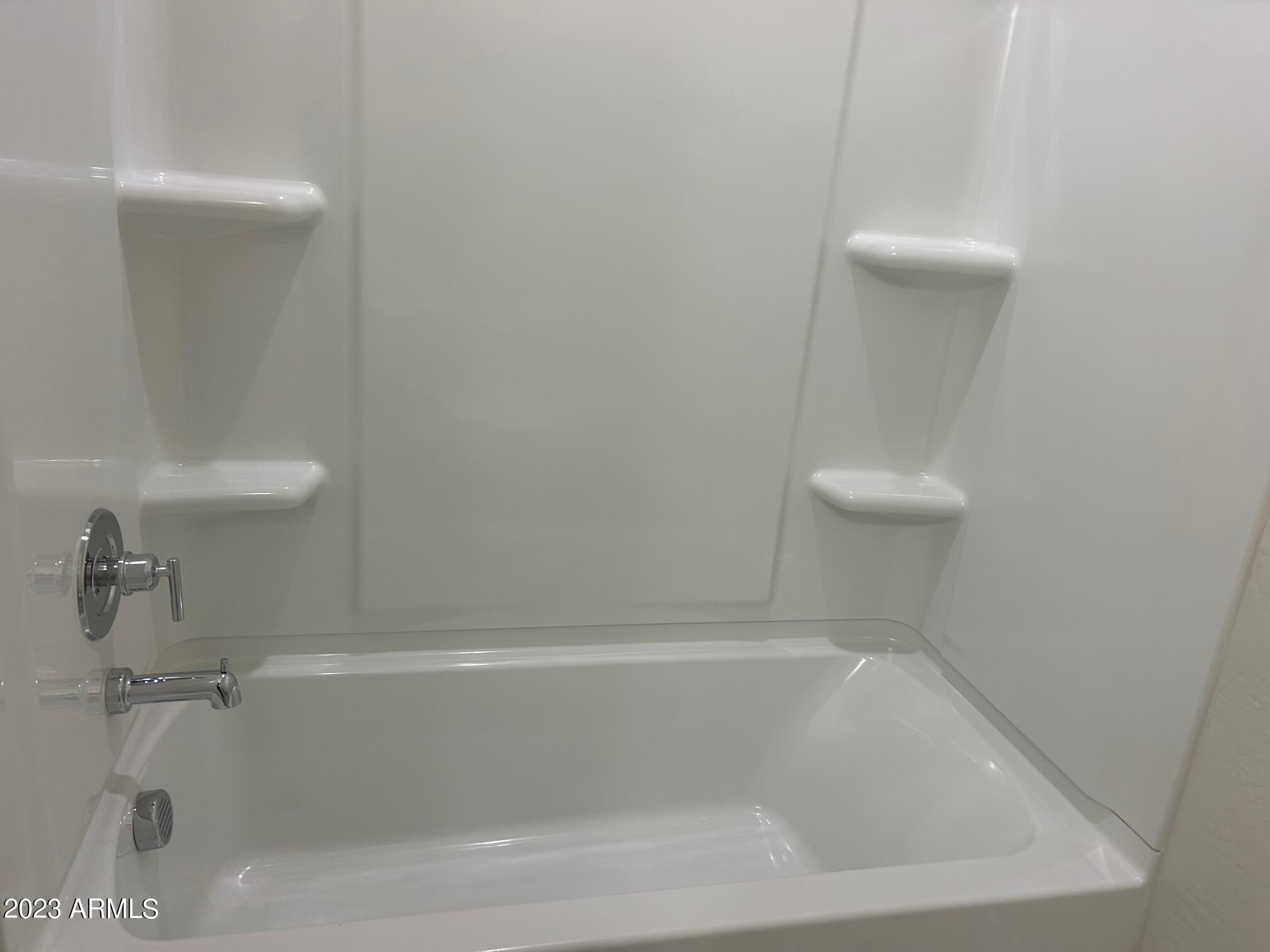 5119 East Emery Road San Tan Valley, AZ 85143 - Photo 15 of 19 a close view of a bathtub in bathroom