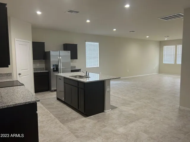 a kitchen with a sink and refrigerator