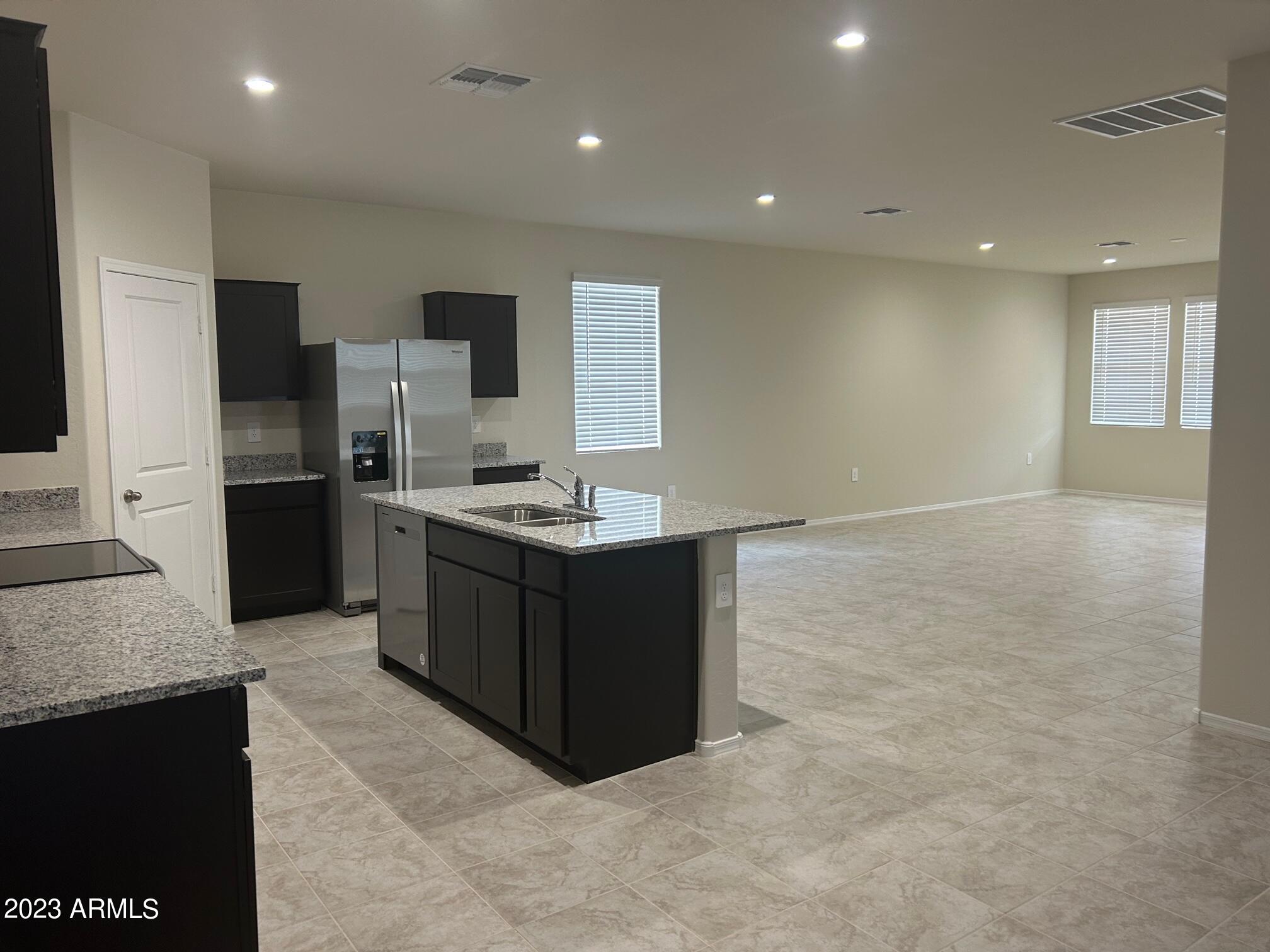 5119 East Emery Road San Tan Valley, AZ 85143 - Photo 3 of 19 a kitchen with a sink and refrigerator