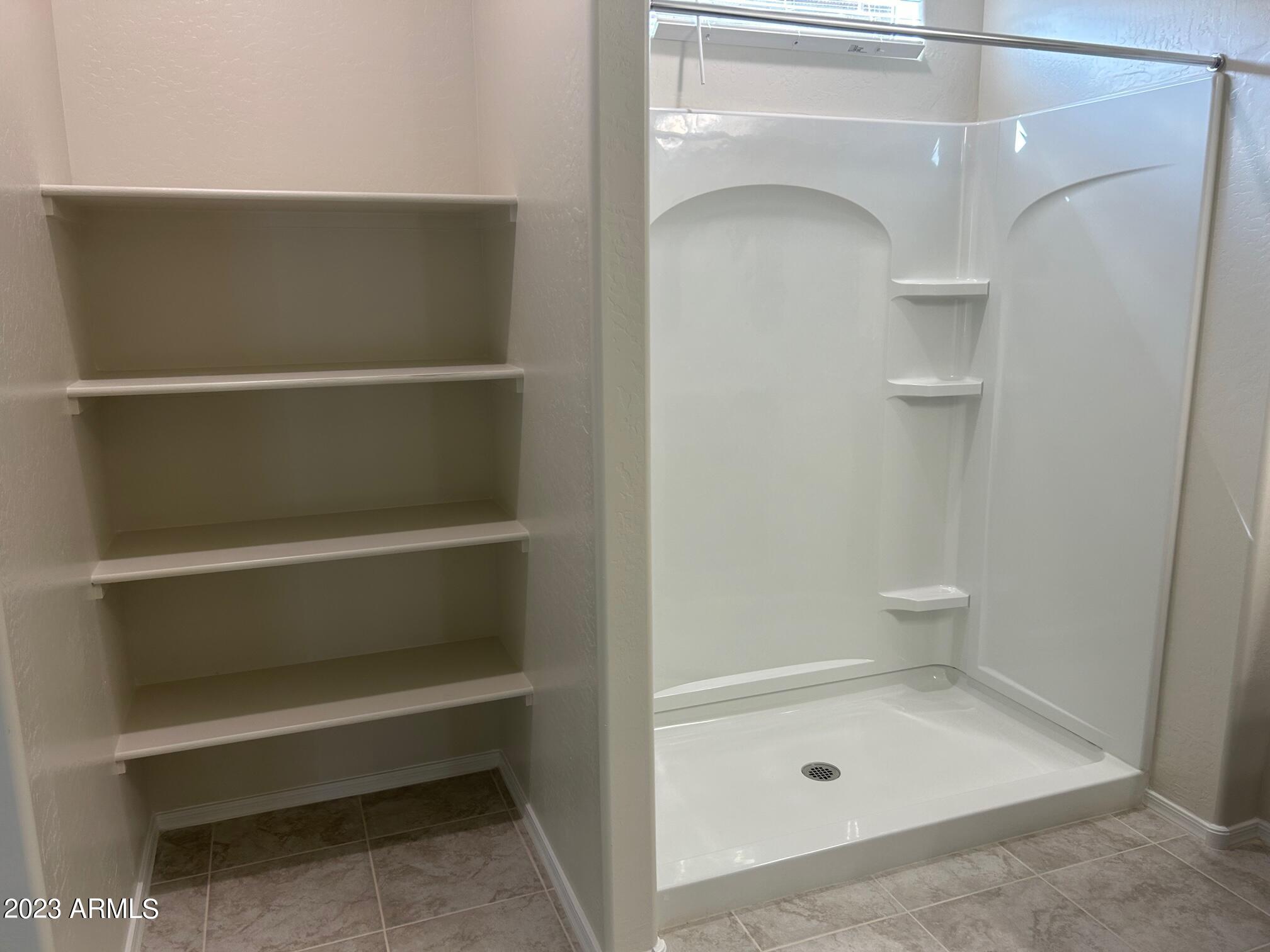 5119 East Emery Road San Tan Valley, AZ 85143 - Photo 10 of 19 a bathroom with a bath tub and a shower