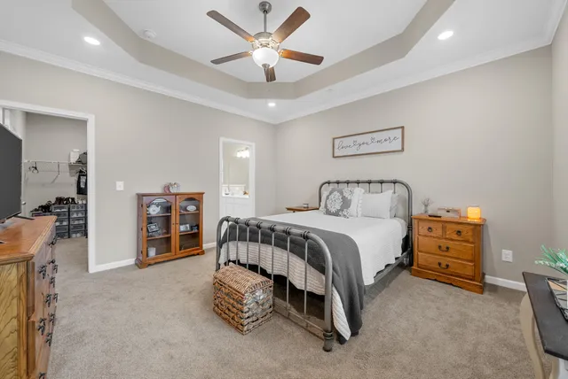 a spacious bedroom with a bed and a chandelier