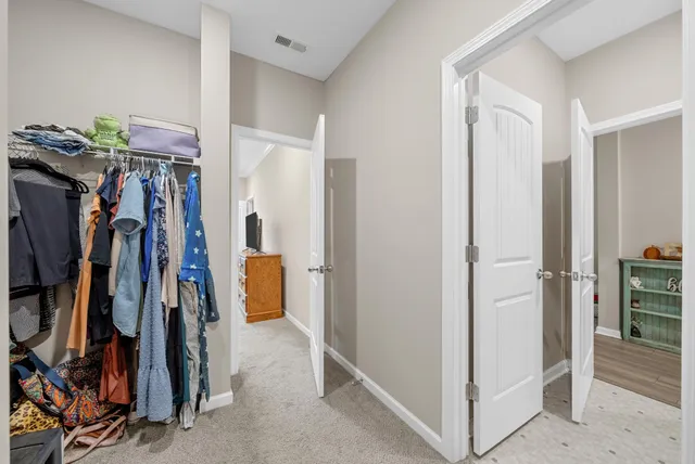 a view of walk in closet with clothes