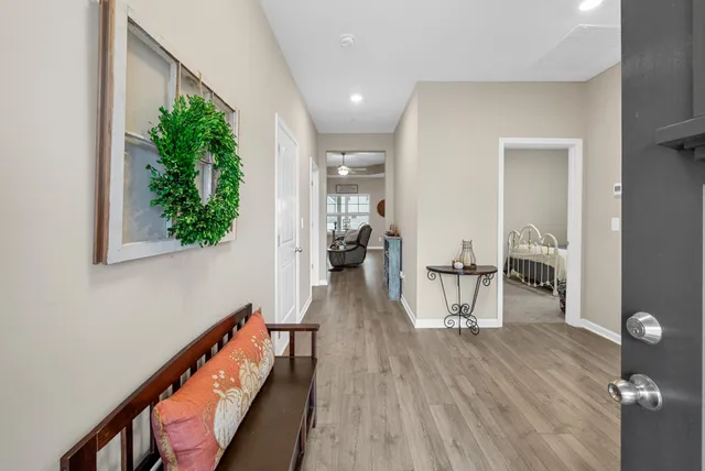 a view of entryway and hall with wooden floor