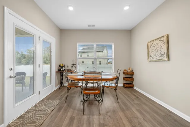 a dining room with a wooden table and chairs