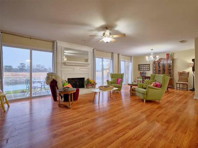 a living room with furniture fireplace and a large window