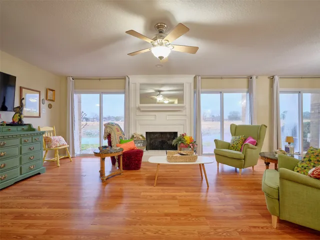 a living room with furniture chandelier and a fireplace