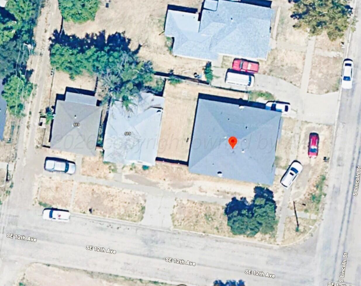 an aerial view of residential houses with outdoor space