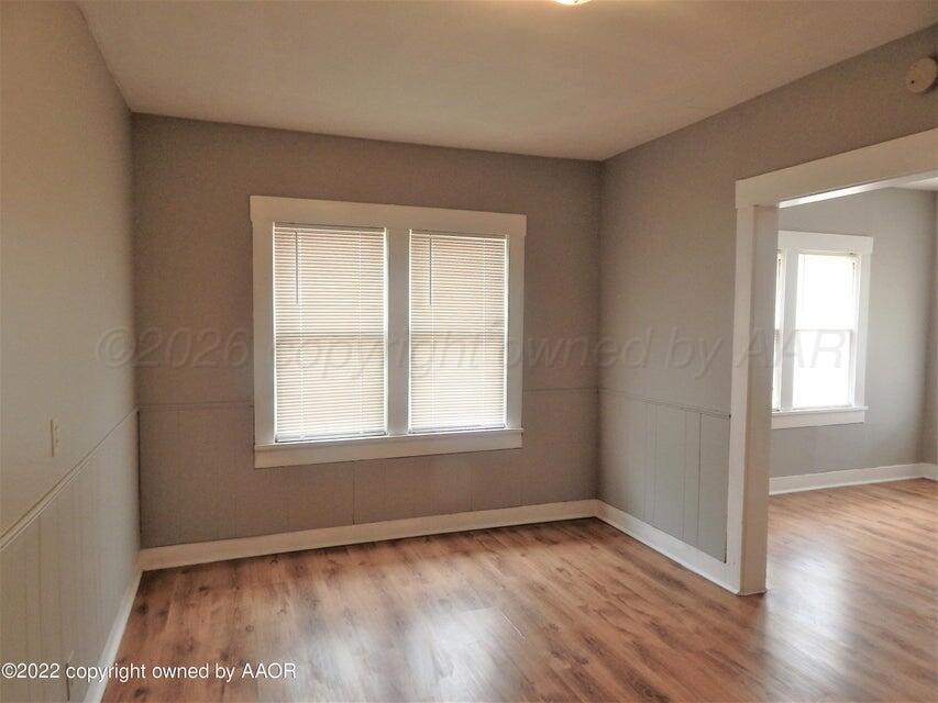 1108 South Lincoln Street Amarillo, TX 79101 - Photo 11 of 25 an empty room with wooden floor and windows