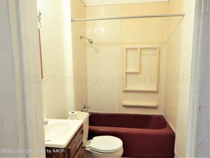 1108 South Lincoln Street Amarillo, TX 79101 - Photo 13 of 25 a bathroom with a sink a toilet and shower