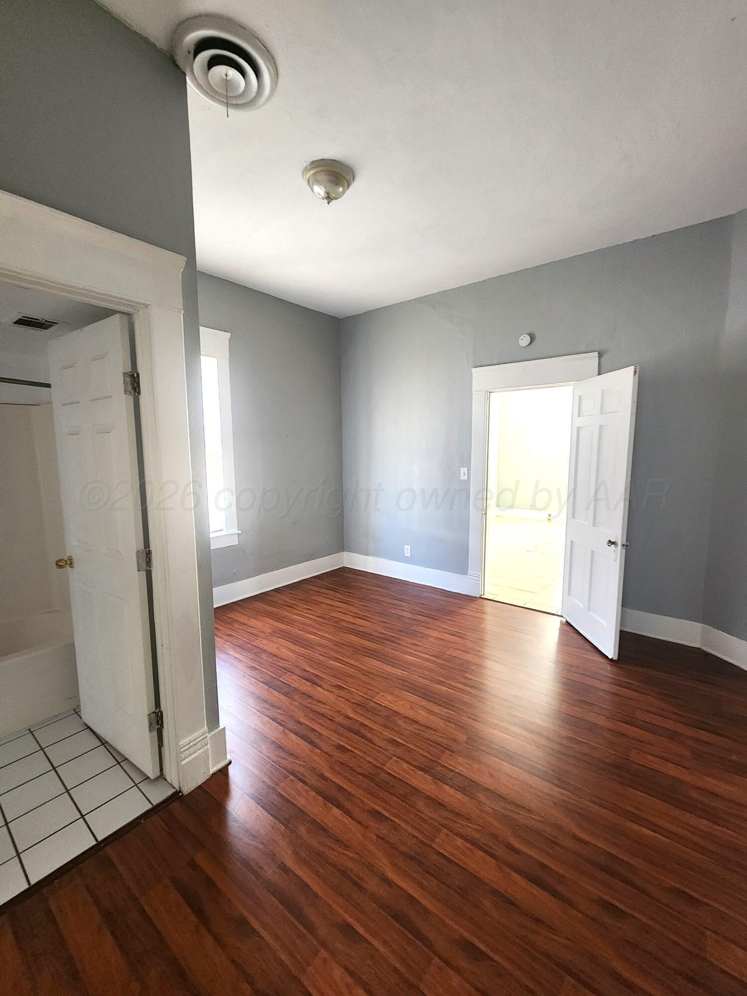 1108 South Lincoln Street Amarillo, TX 79101 - Photo 20 of 25 an empty room with wooden floor and window