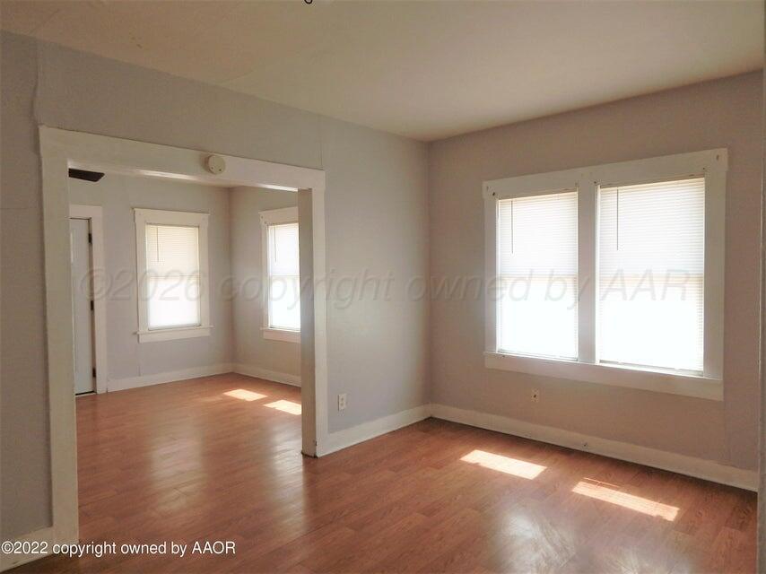 1108 South Lincoln Street Amarillo, TX 79101 - Photo 6 of 25 a view of an empty room with wooden floor and a window