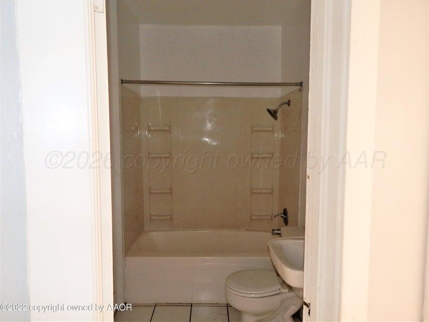 1108 South Lincoln Street Amarillo, TX 79101 - Photo 8 of 25 a bathroom with a shower and a toilet