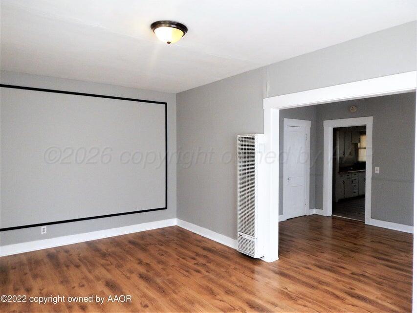 1108 South Lincoln Street Amarillo, TX 79101 - Photo 9 of 25 a view of an empty room with wooden floor