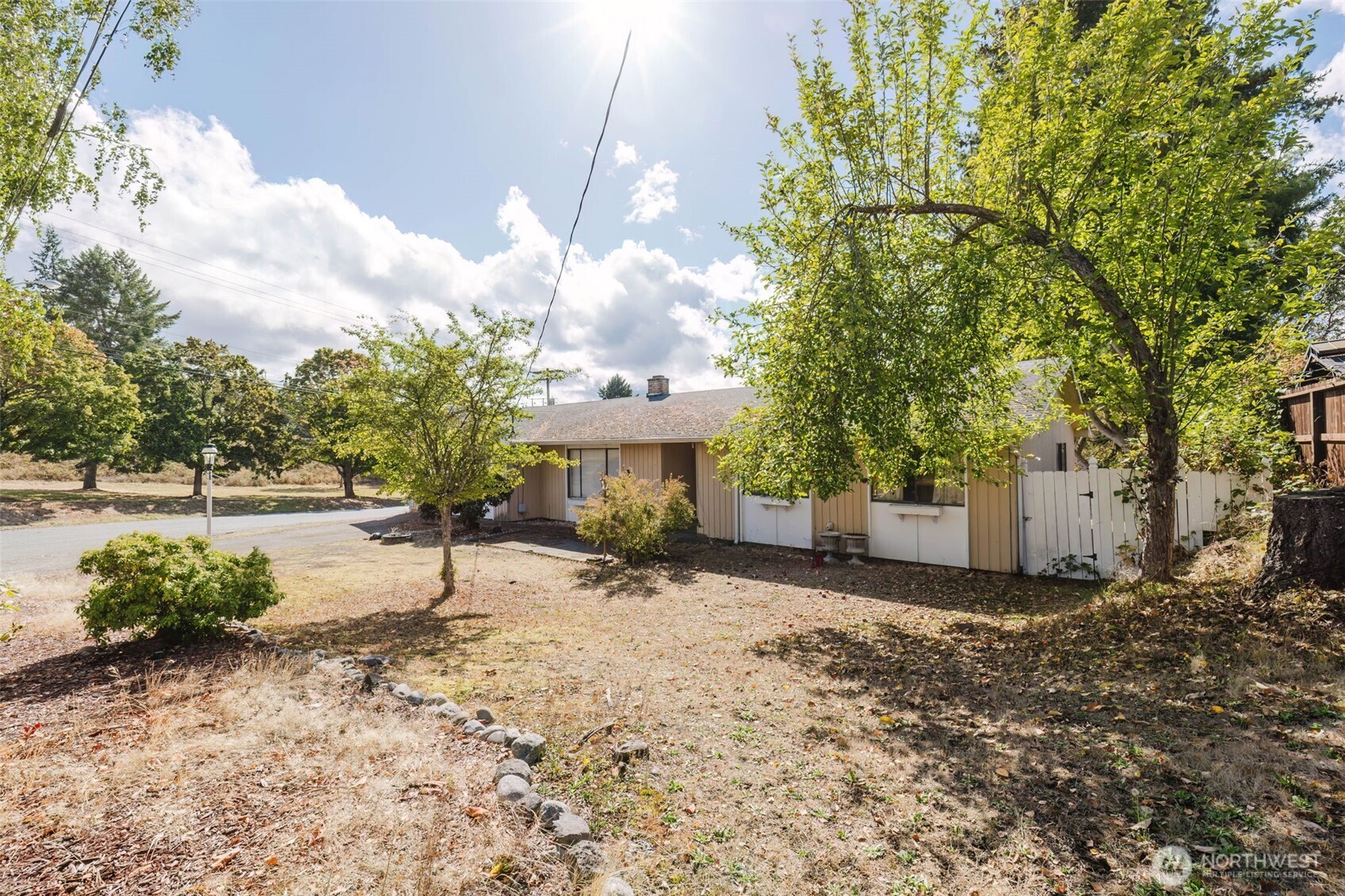 567 Juniper Street Bremerton, WA 98310 - Photo 28 of 37 a view of a house with a tree and a yard