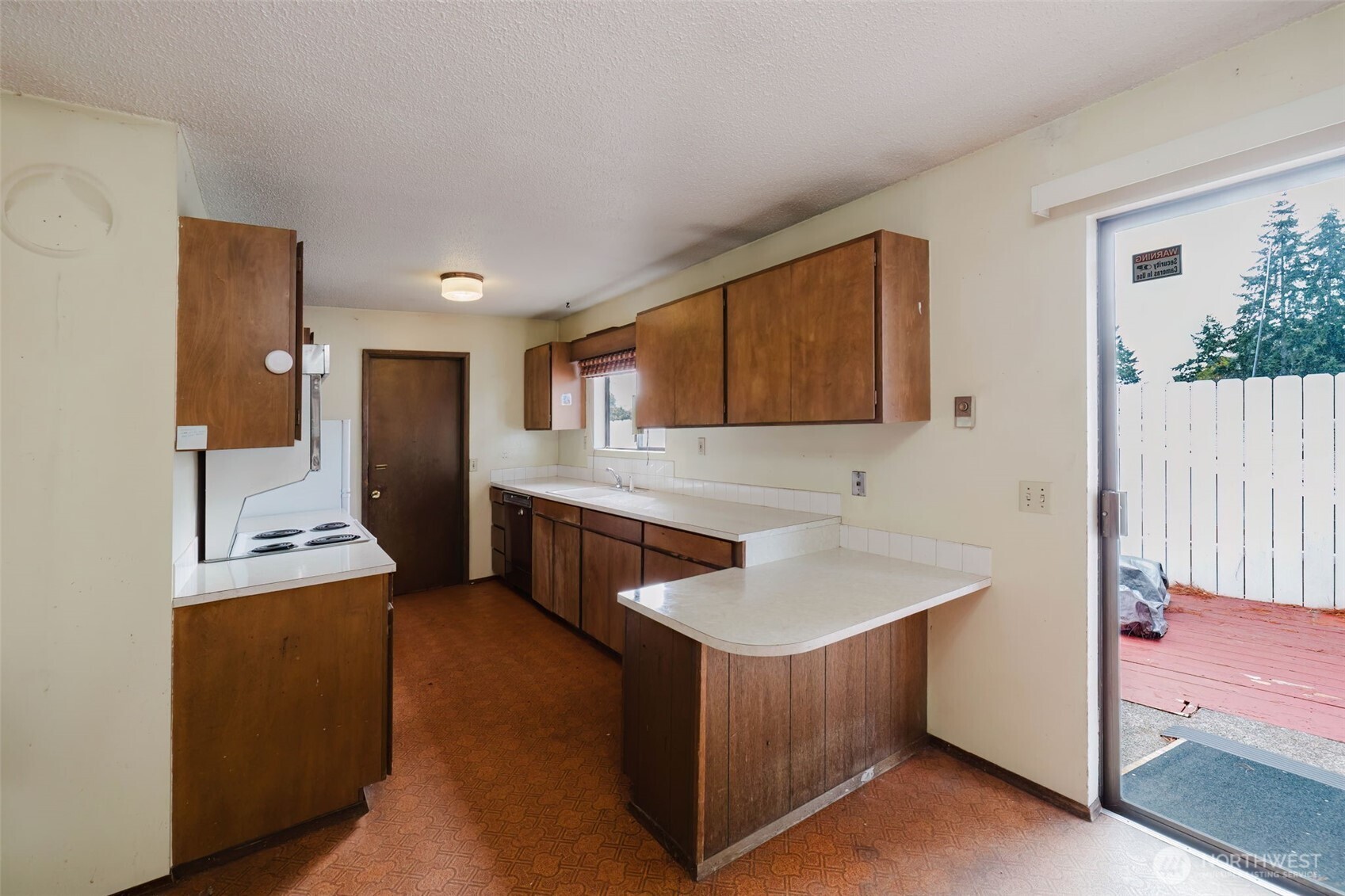 567 Juniper Street Bremerton, WA 98310 - Photo 6 of 37 a kitchen with granite countertop a sink stove and cabinets