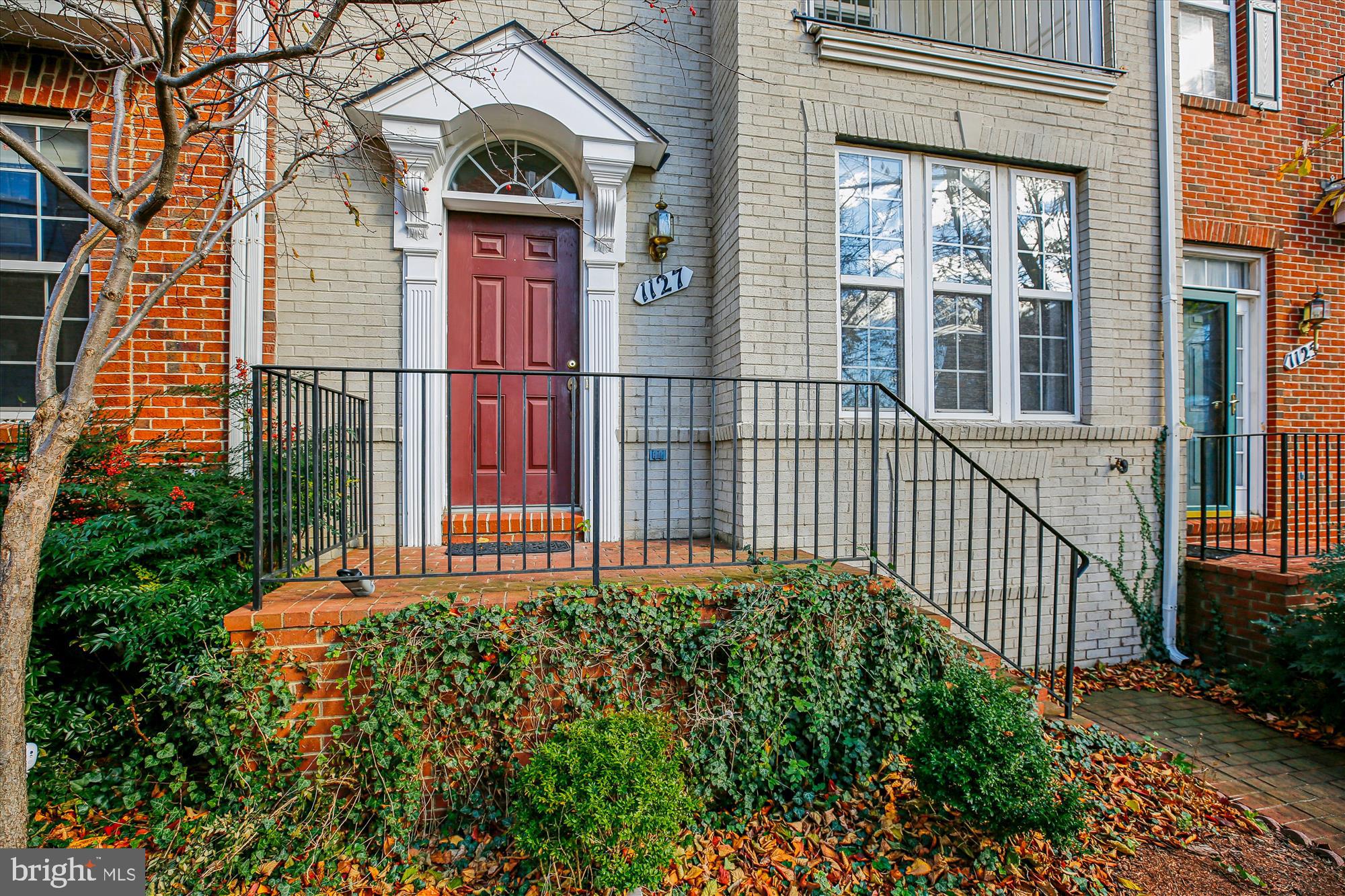 1127 Gaither Road Rockville, MD 20850 - Photo 2 of 36 a view of a house with a small yard and flower plants