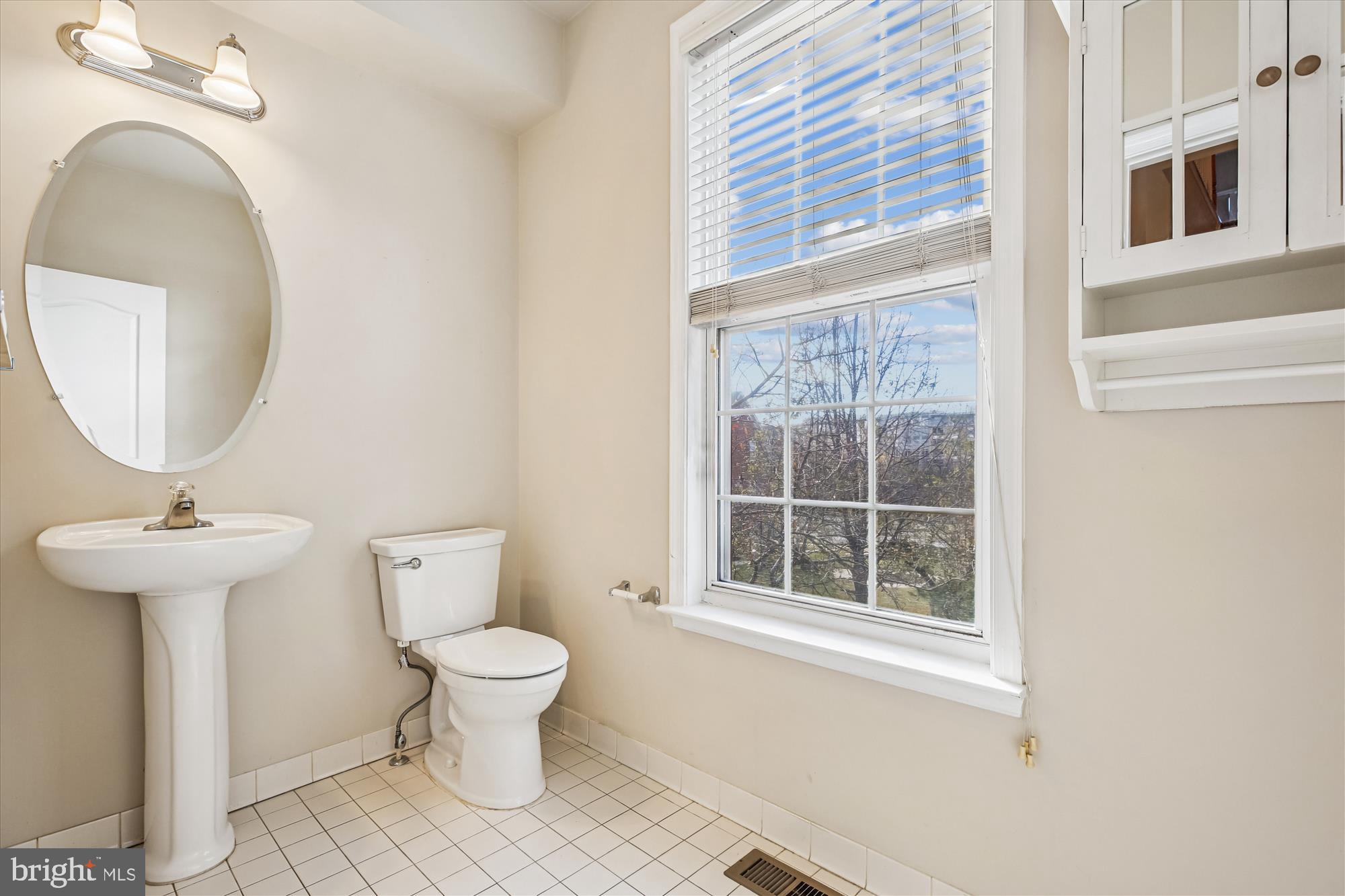 1127 Gaither Road Rockville, MD 20850 - Photo 29 of 36 a bathroom with a sink a toilet and a mirror