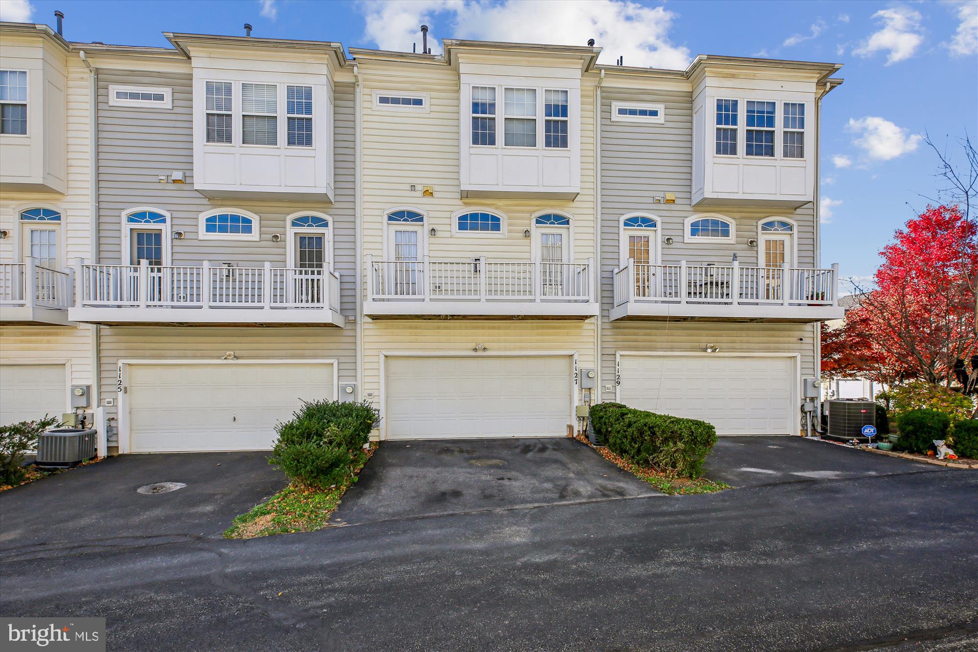 1127 Gaither Road Rockville, MD 20850 - Photo 4 of 36 a front view of a building with a yard and plants