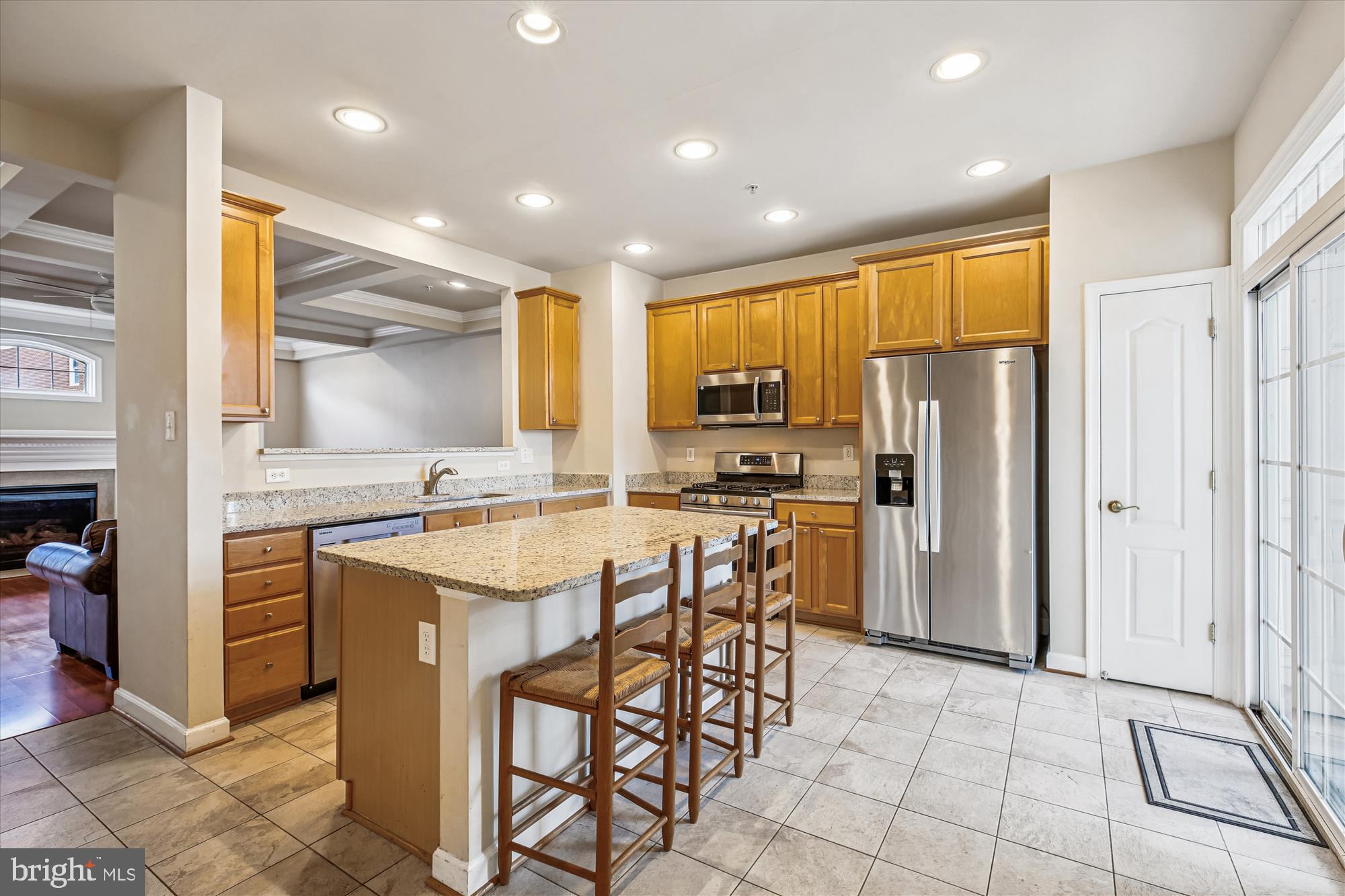 1127 Gaither Road Rockville, MD 20850 - Photo 10 of 36 a kitchen with stainless steel appliances a refrigerator a stove a sink and white cabinets with wooden floor