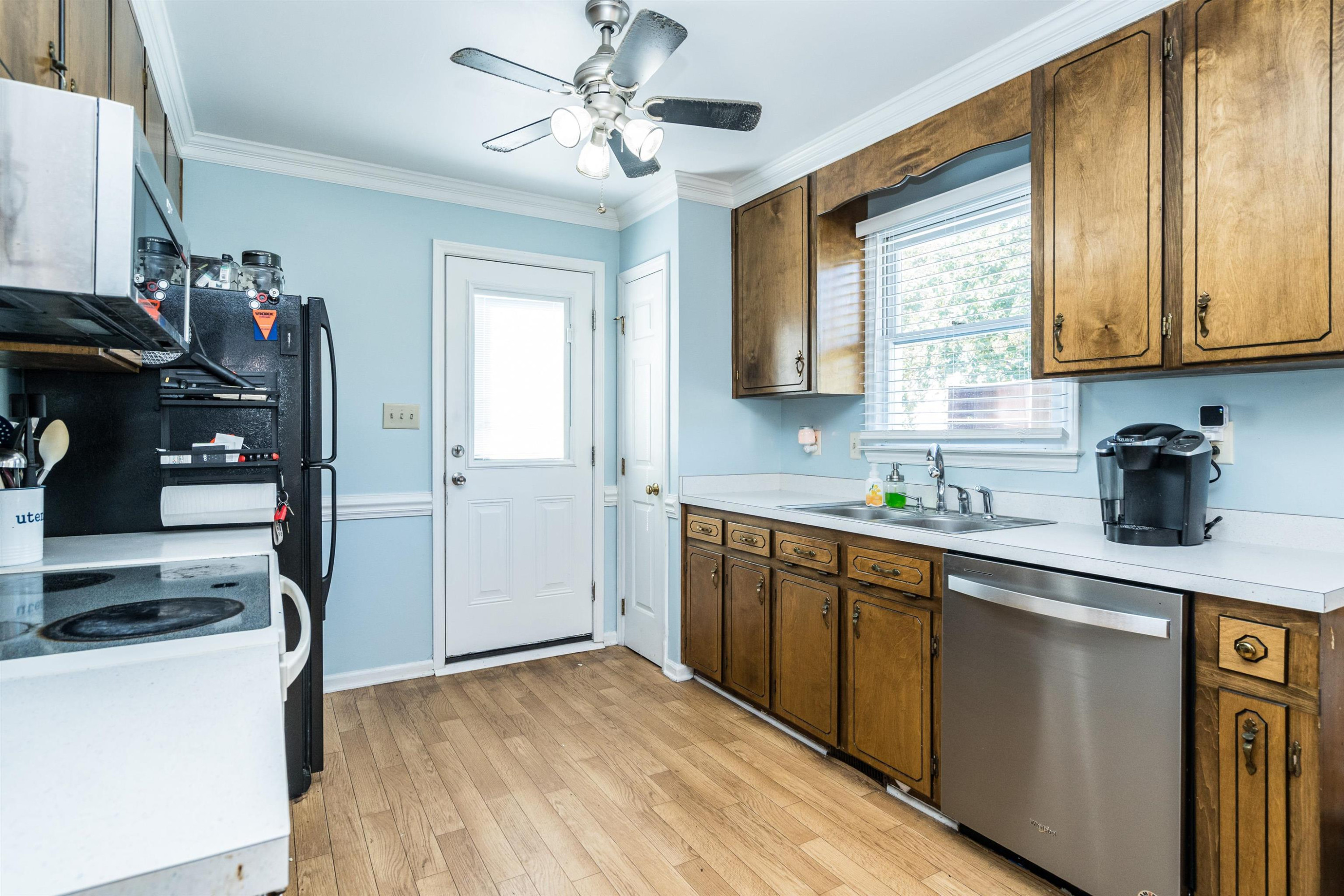 429 Government Road Clayton, NC 27520 - Photo 11 of 27 a kitchen with stainless steel appliances granite countertop a sink cabinets and wooden floor