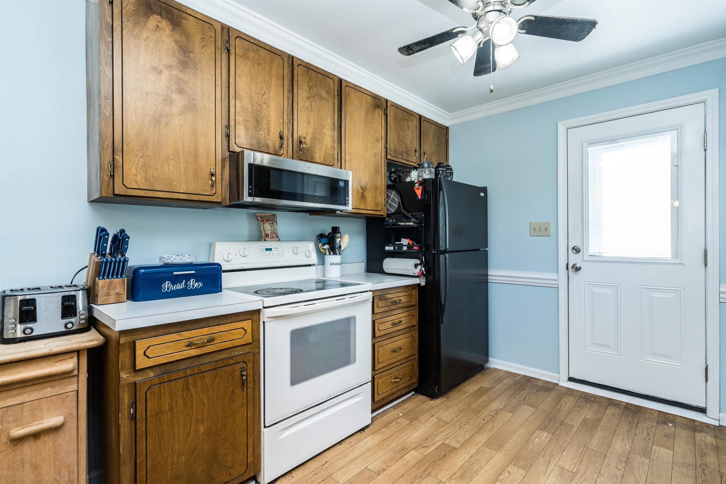 429 Government Road Clayton, NC 27520 - Photo 12 of 27 a kitchen with a stove microwave and refrigerator