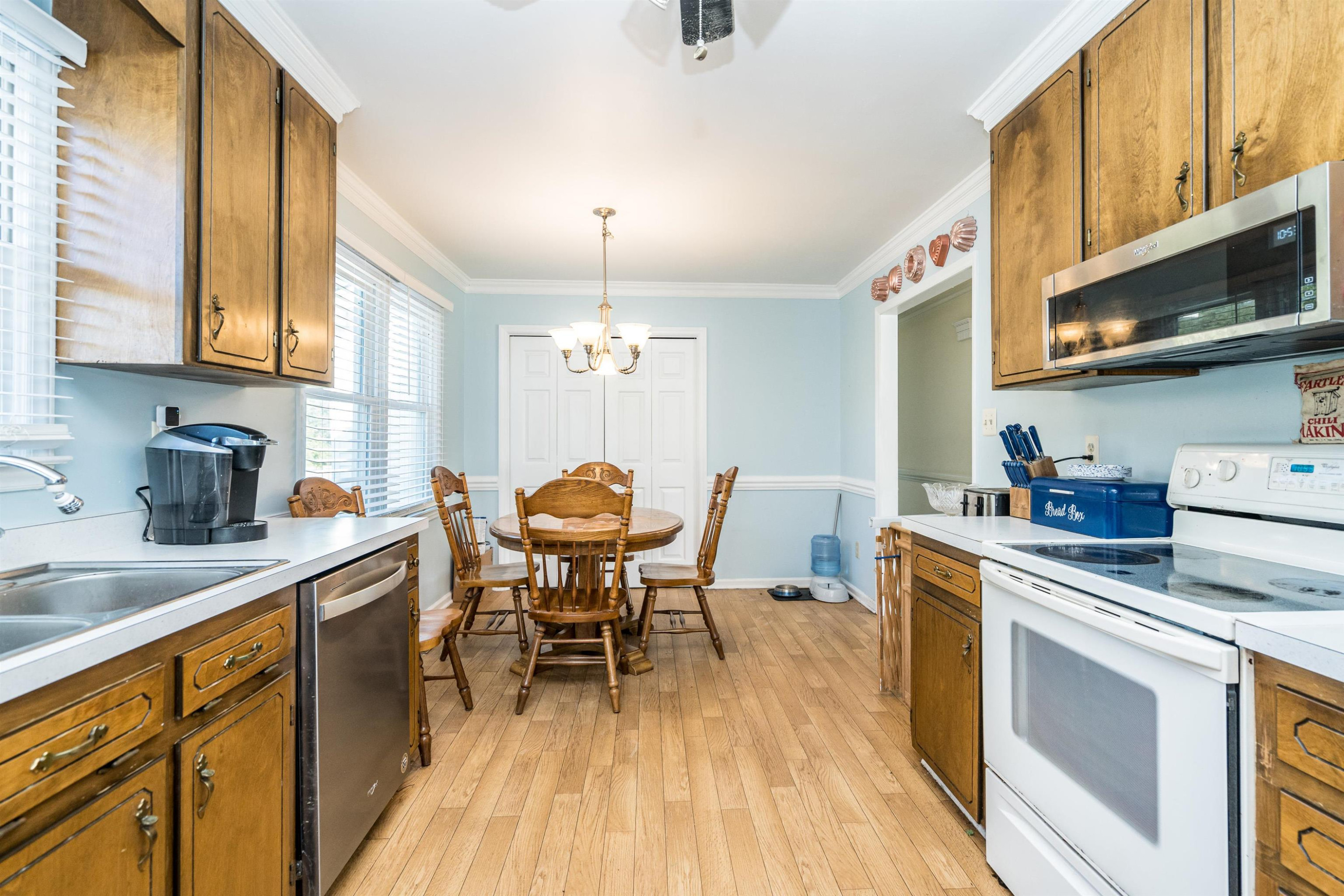 429 Government Road Clayton, NC 27520 - Photo 13 of 27 a kitchen with a stove a sink and cabinets