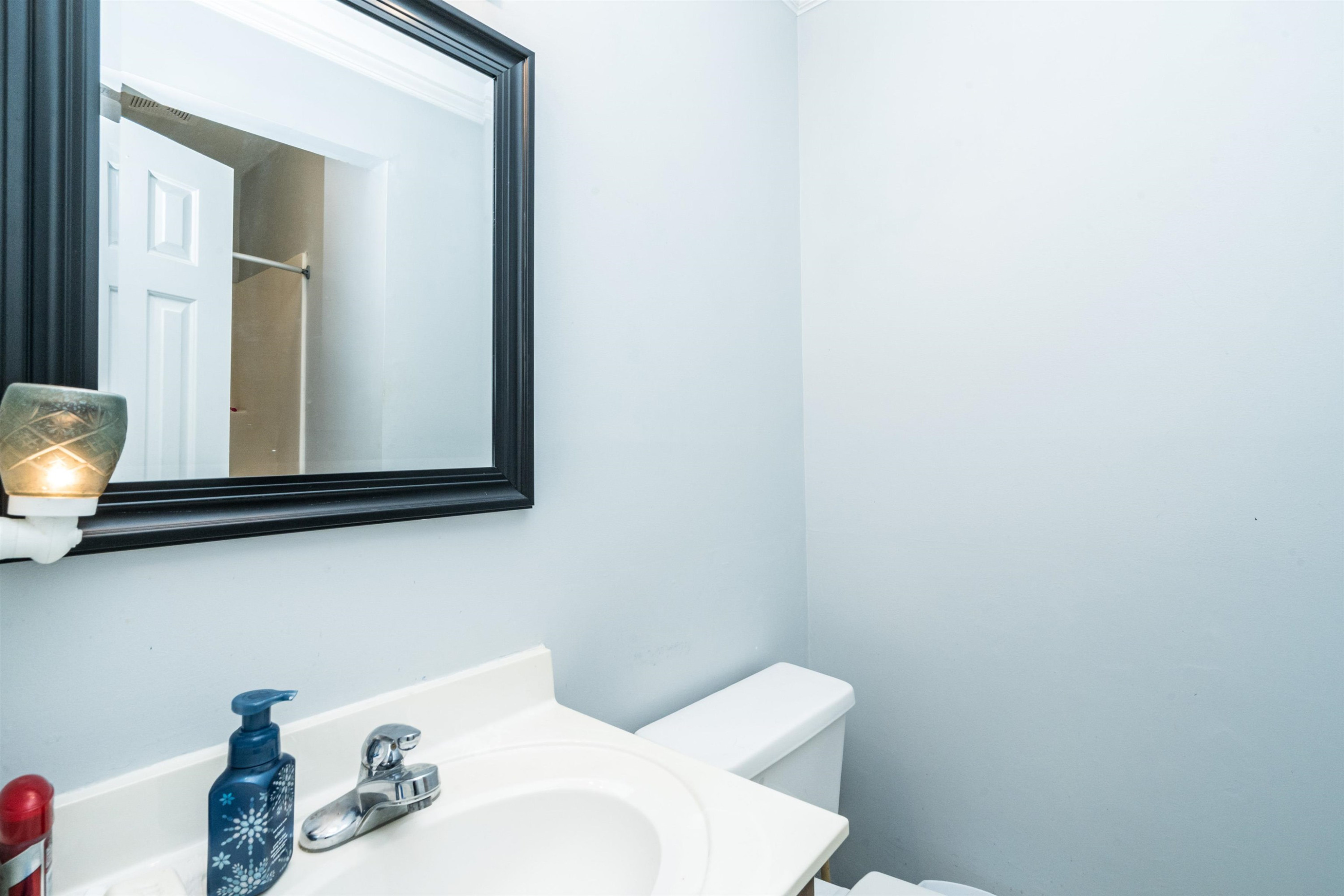 429 Government Road Clayton, NC 27520 - Photo 17 of 27 a bathroom with a toilet sink and mirror