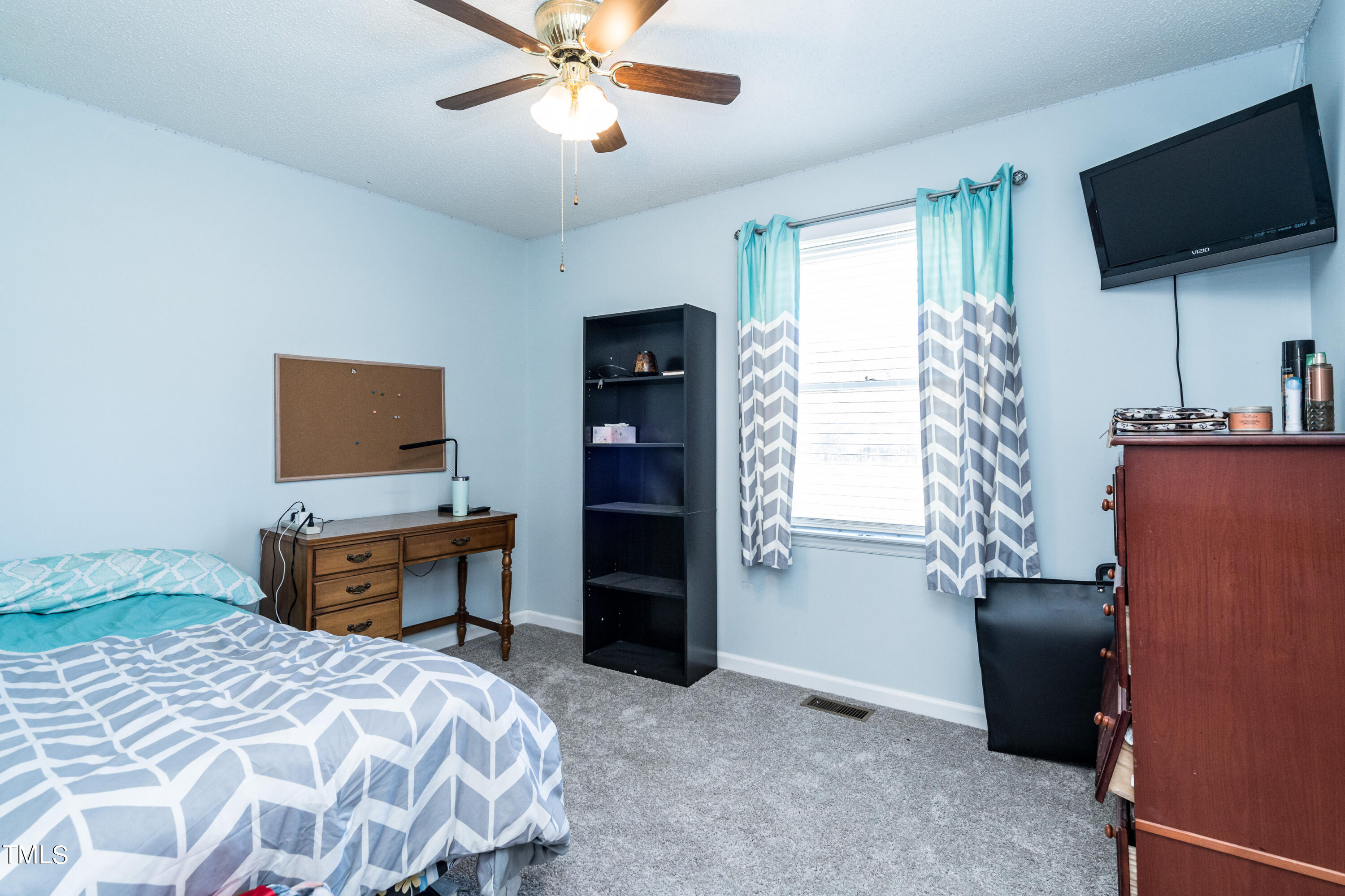 429 Government Road Clayton, NC 27520 - Photo 18 of 27 a bedroom with a bed and a flat screen tv