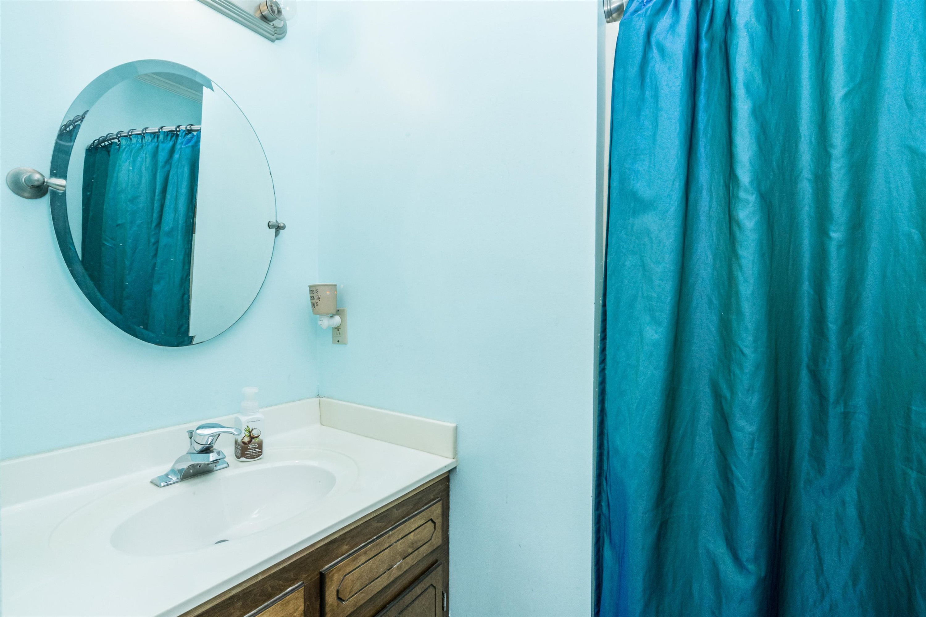 429 Government Road Clayton, NC 27520 - Photo 19 of 27 a bathroom with a sink and a mirror
