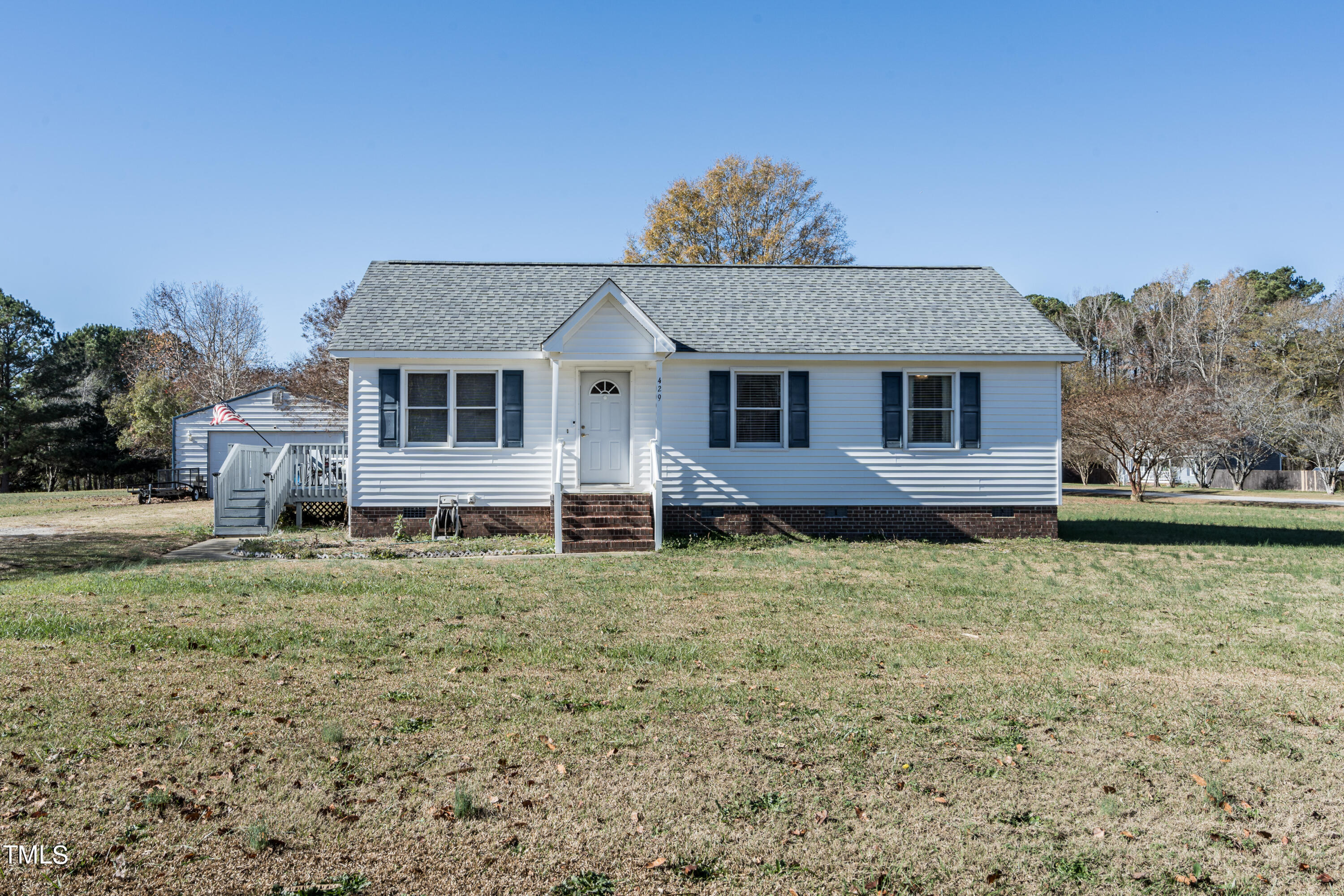 429 Government Road Clayton, NC 27520 - Photo 2 of 27 a house that has a tree in the grass