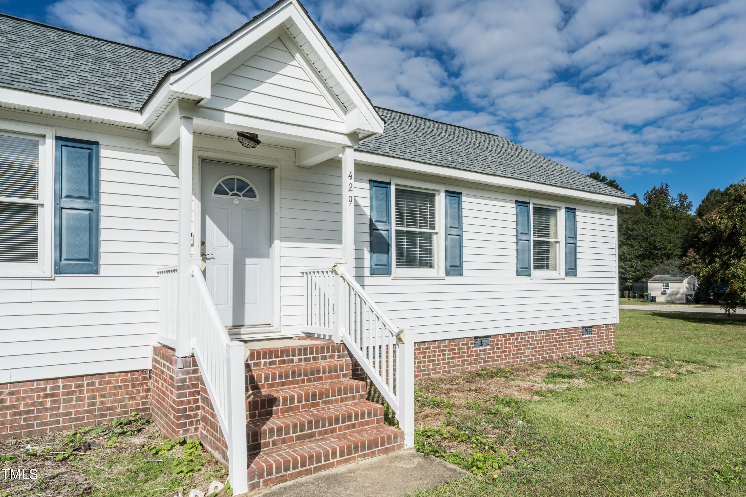 429 Government Road Clayton, NC 27520 - Photo 3 of 27 a front view of a house with a garden