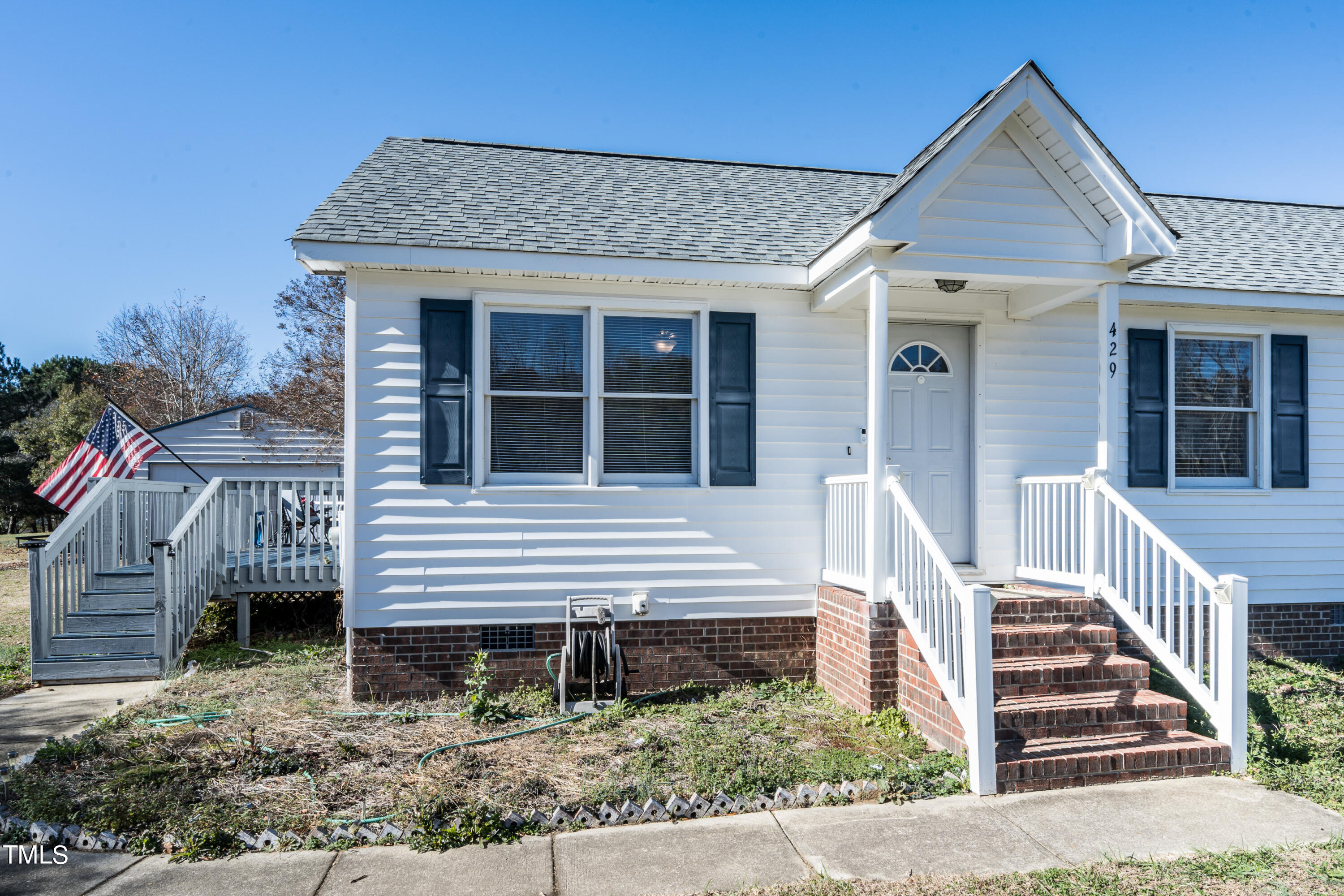 429 Government Road Clayton, NC 27520 - Photo 4 of 27 a front view of a house with a porch