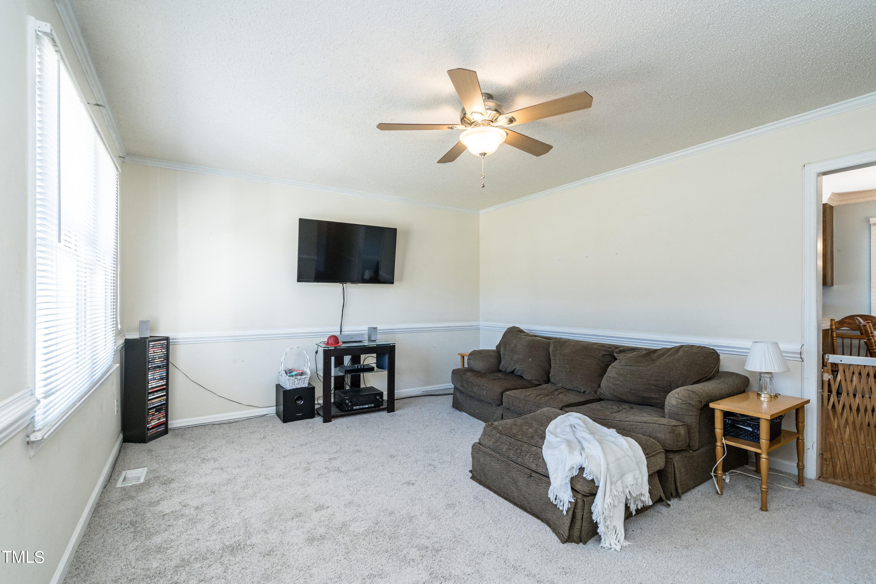429 Government Road Clayton, NC 27520 - Photo 6 of 27 a living room with furniture and a flat screen tv