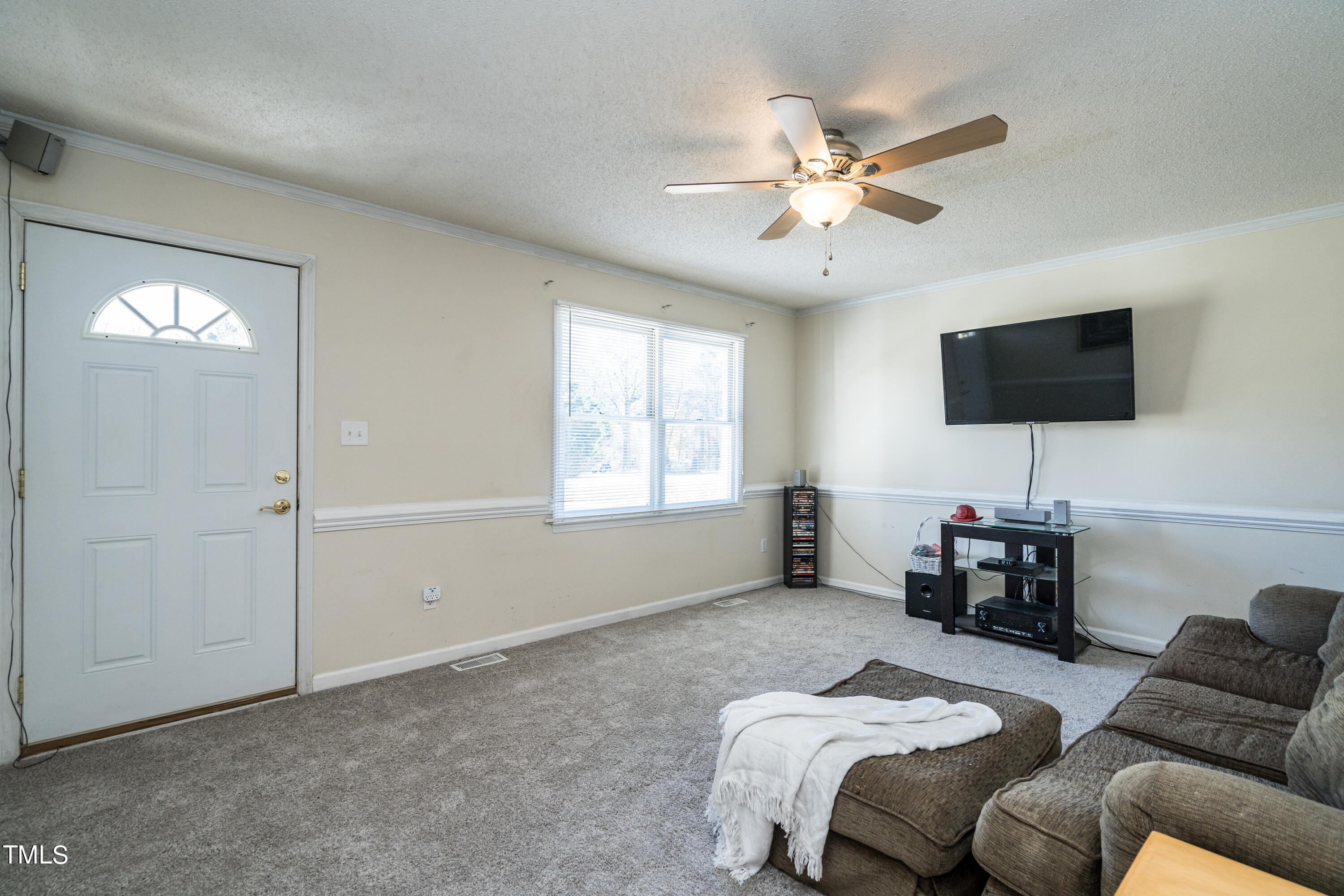 429 Government Road Clayton, NC 27520 - Photo 7 of 27 a bedroom with a bed window and a flat screen tv