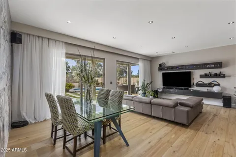 a living room with furniture flat screen tv and a large window