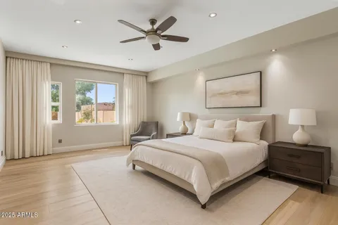 a bedroom with a large bed and a window