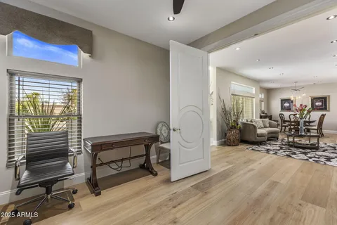 a living room with furniture a table and wooden floor