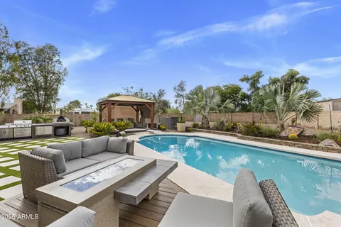a view of a swimming pool with couches and city view
