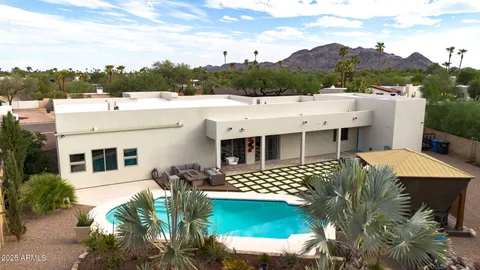 a aerial view of a house with a garden and lake view