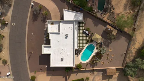 an aerial view of a house with a yard