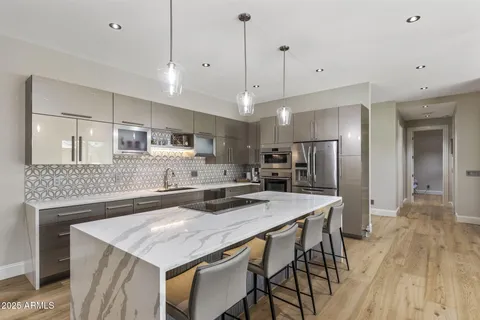 a kitchen with kitchen island a sink stove and refrigerator
