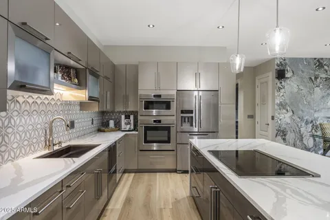 a kitchen with a sink appliances and cabinets