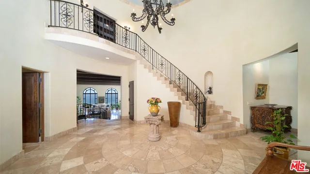 a living room with furniture a fireplace and a floor to ceiling window