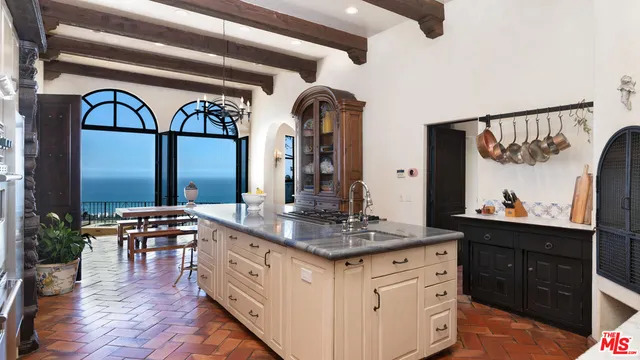 a kitchen with stainless steel appliances granite countertop a stove and a clock