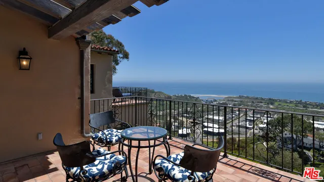 a dining room with furniture a fireplace and wooden floor