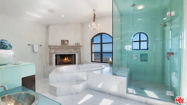 a bathroom with a sink a mirror and a shower