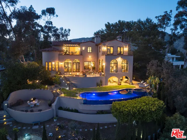 a view of a patio with couches table and chairs and potted plants